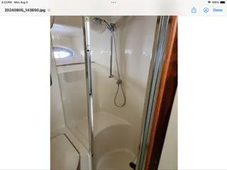 Slide: The Image of 2004 Sea Ray 480 Sedan Bridge yacht bathroom with shower and porthole window. - 35