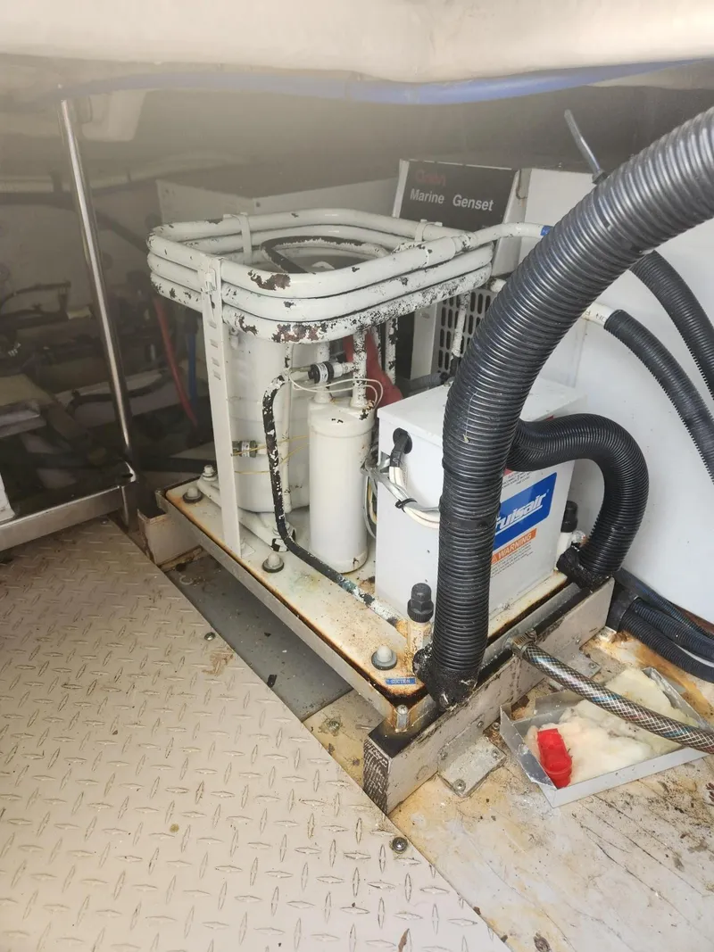 Slide: The Image of Engine room of 2004 Sea Ray 480 Sedan Bridge with marine generator and equipment. - 45