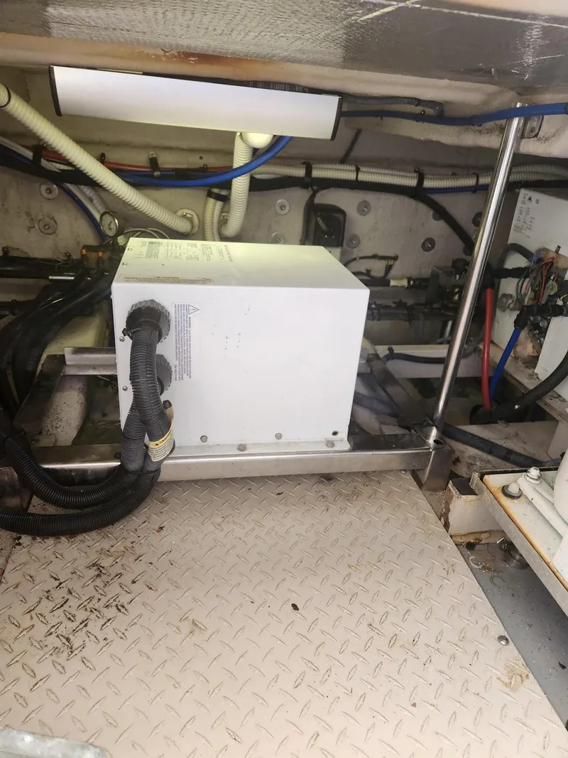 Slide: The Image of Engine room of 2004 Sea Ray 480 Sedan Bridge with visible wiring and equipment. - 46