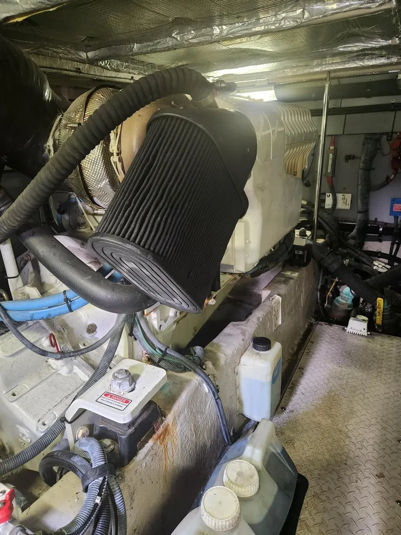 Slide: The Image of Engine room of 2004 Sea Ray 480 Sedan Bridge with visible components and wiring. - 48