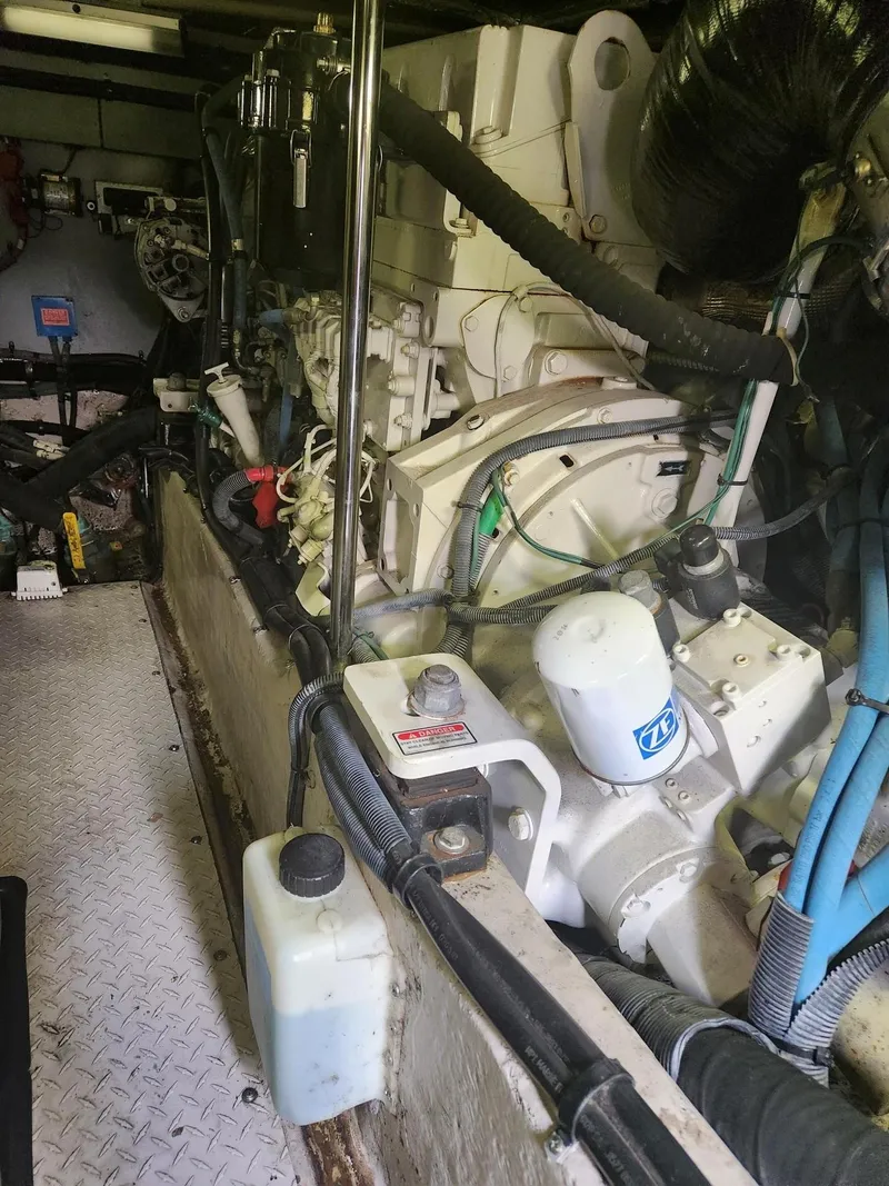 Slide: The Image of Engine room of a 2004 Sea Ray 480 Sedan Bridge yacht, showcasing mechanical components. - 49