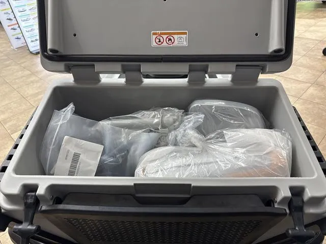 Slide: The Image of Open storage compartment of 2025 Sea-Doo Waverunner FISH PRO with packaged items inside. - 12