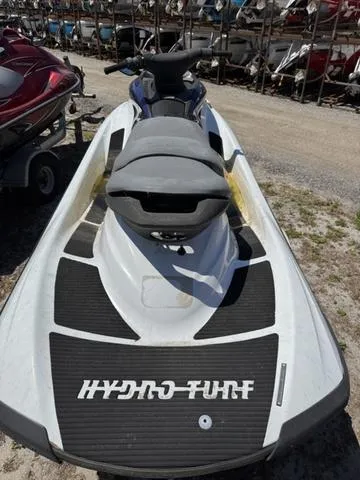 Slide: The Image of 2004 Yamaha WaveRunner FX jet ski with Hydro-Turf mat, parked outdoors. - 4