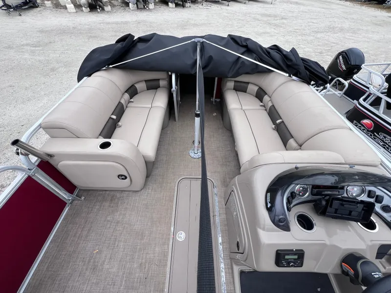 Slide: The Image of 2022 Sun Tracker Party Barge 22 RF XP3 interior with beige seating and steering console. - 16