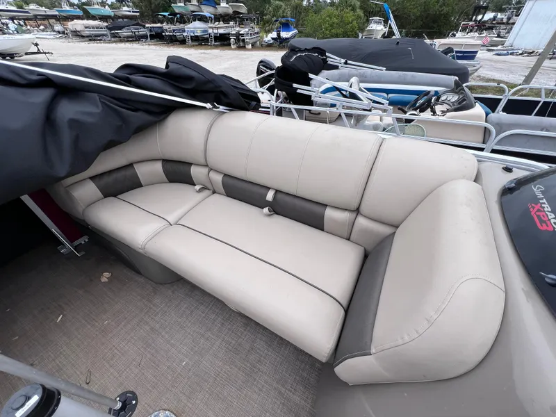 Slide: The Image of 2022 Sun Tracker Party Barge 22 RF XP3 with beige seating, docked at marina. - 18