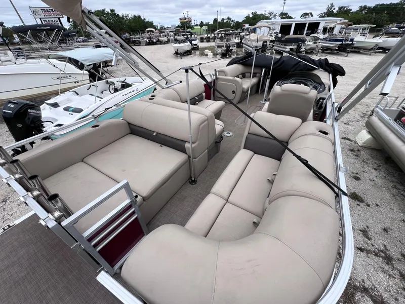 Slide: The Image of 2022 Sun Tracker Party Barge 22 RF XP3 with spacious seating in a marina setting. - 5