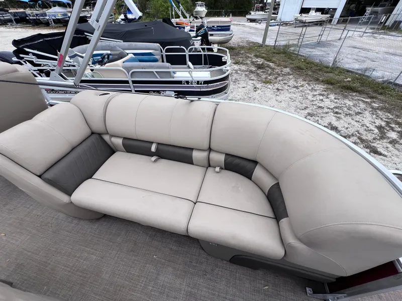 Slide: The Image of 2022 Sun Tracker Party Barge 22 RF XP3 pontoon boat with beige seating, docked outdoors. - 8