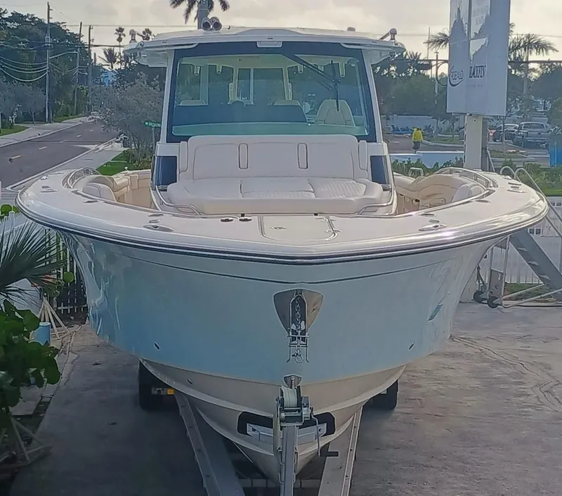 Slide: The Image of 2025 Grady-White Canyon 456 boat on trailer, front view, parked outdoors. - 3