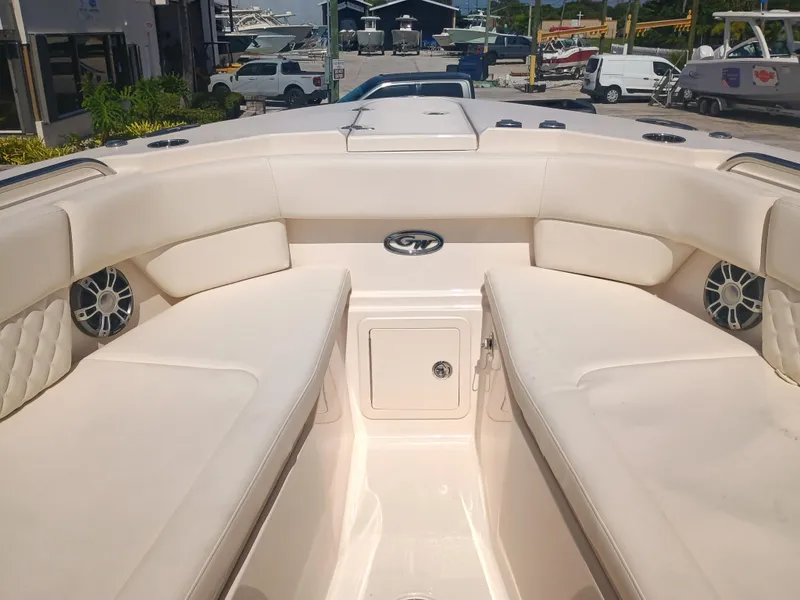 Slide: The Image of 2025 Grady-White Canyon 456 boat interior with cushioned seating and storage compartment. - 35