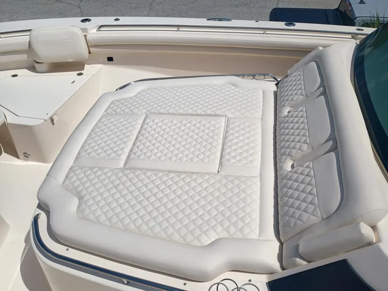 Slide: The Image of Luxurious seating on 2025 Grady-White Canyon 456 boat, featuring quilted white upholstery. - 42