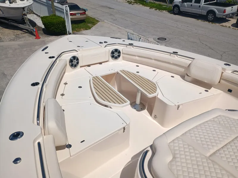 Slide: The Image of 2025 Grady-White Canyon 456 boat interior with seating and table setup. - 43