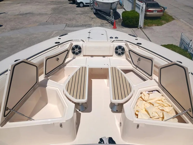 Slide: The Image of 2025 Grady-White Canyon 456 boat interior with open storage compartments and seating area. - 44