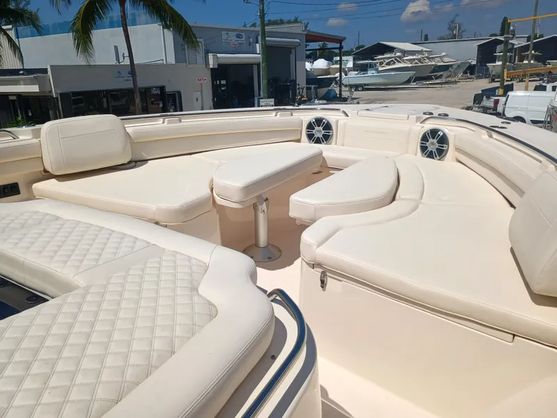 Slide: The Image of Luxurious seating area on 2025 Grady-White Canyon 456 boat, featuring plush white upholstery. - 47