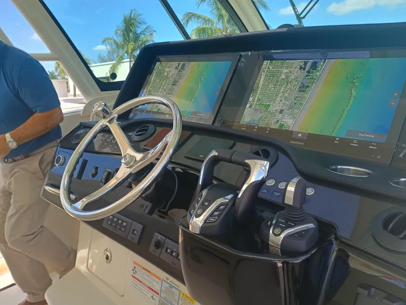 Slide: The Image of 2025 Grady-White Canyon 456 helm with dual Garmin displays and steering wheel. - 48