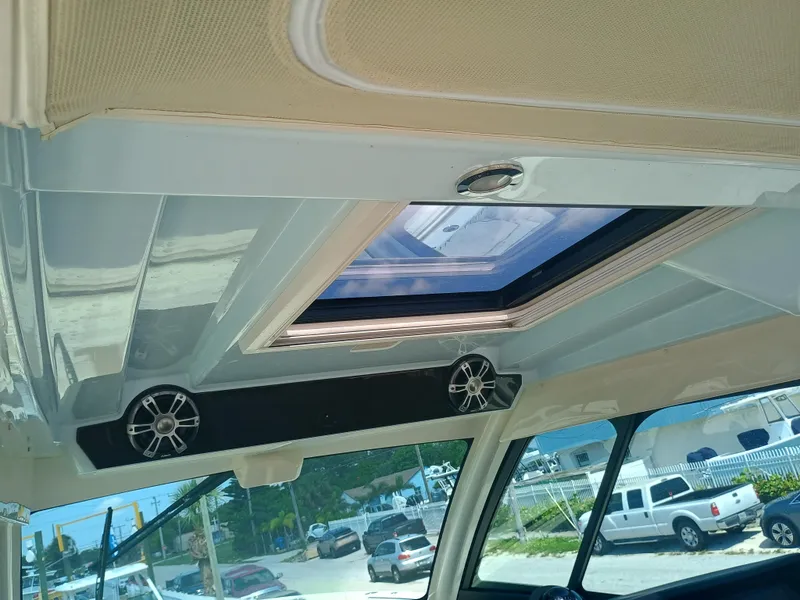 Slide: The Image of Interior view of 2025 Grady-White Canyon 456 boat with sunroof and speakers. - 49