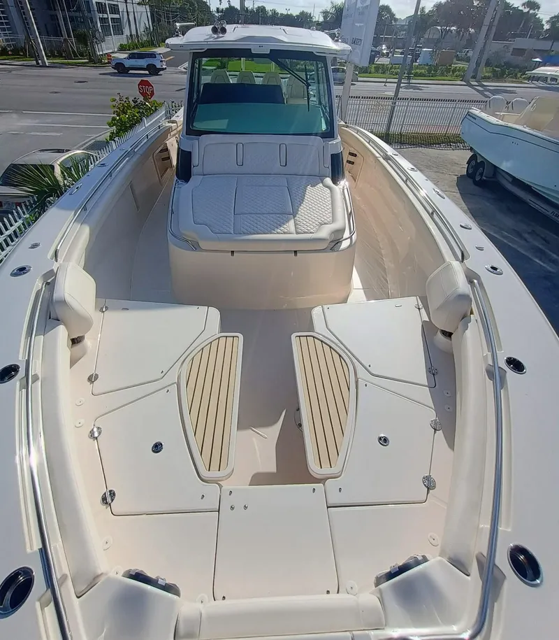Slide: The Image of 2025 Grady-White Canyon 456 boat, spacious deck, modern design, docked in a marina. - 8