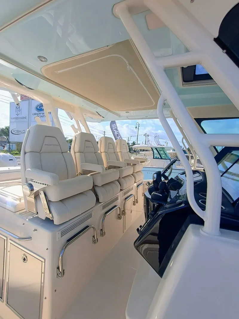 Slide: The Image of 2025 Grady-White Canyon 456 boat interior with luxurious seating and modern helm. - 9