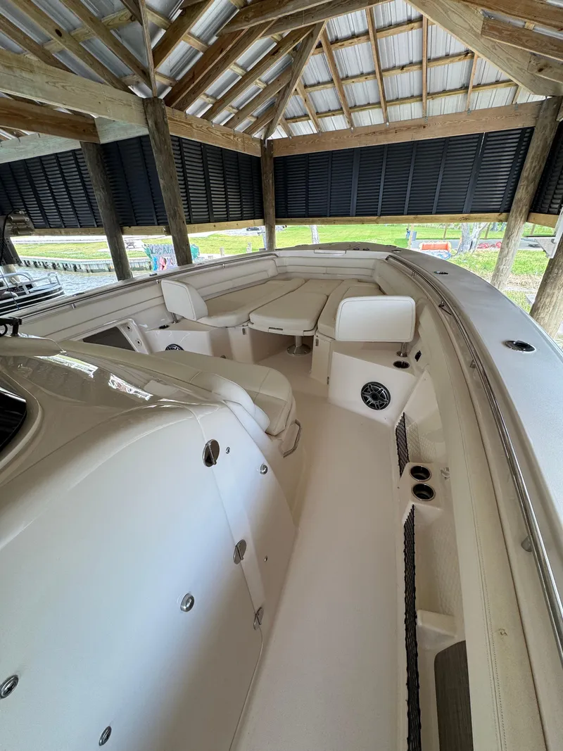 Slide: The Image of 2023 Grady-White Canyon 376 boat interior under a wooden shelter. - 10