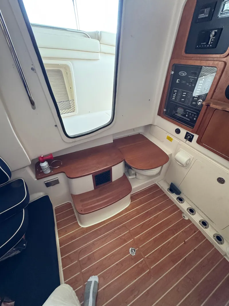 Slide: The Image of 2023 Grady-White Canyon 376 interior with wooden flooring and control panel. - 12