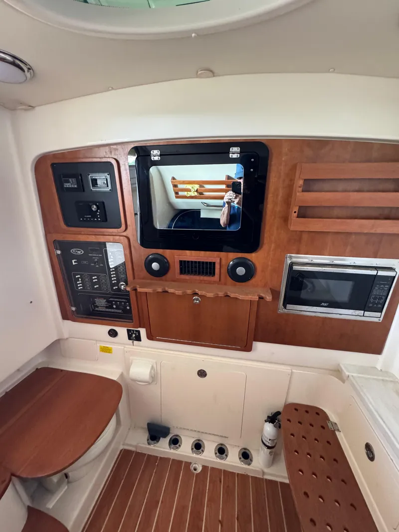 Slide: The Image of 2023 Grady-White Canyon 376 cabin interior with control panel and seating. - 13