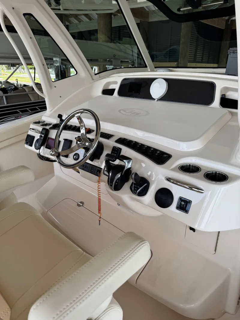 Slide: The Image of 2023 Grady-White Canyon 376 helm with steering wheel and controls. - 19