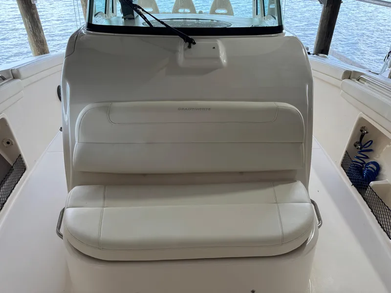 Slide: The Image of 2023 Grady-White Canyon 376 boat interior with cushioned seating and helm station. - 23
