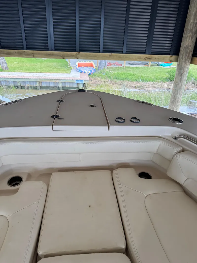 Slide: The Image of 2023 Grady-White Canyon 376 boat interior with cushioned seating under a covered dock. - 24