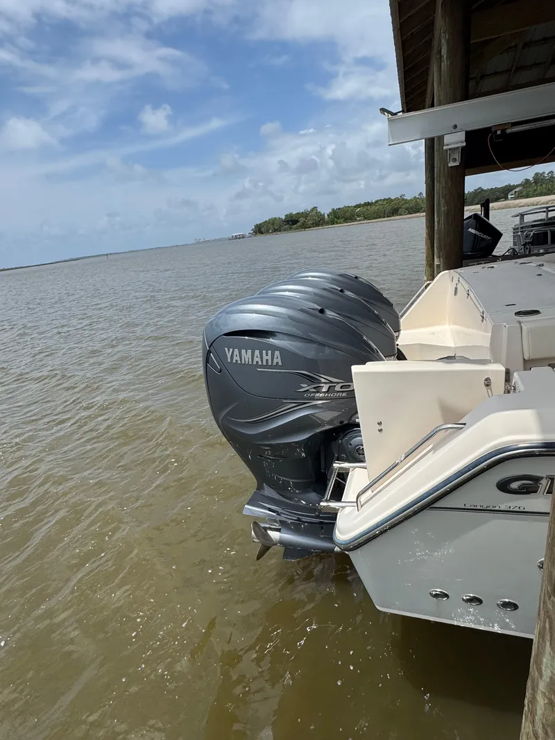 Slide: The Image of 2023 Grady-White Canyon 376 boat with Yamaha engines docked by the water. - 4