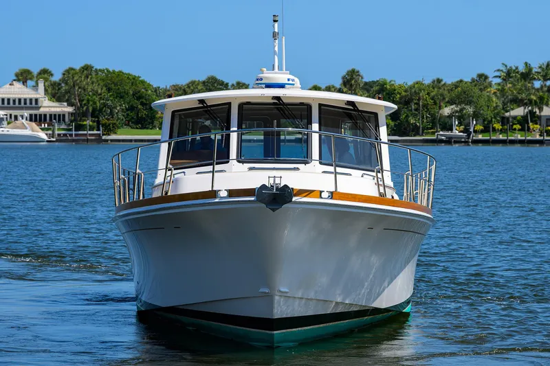 Slide: The Image of 2014 Grand Banks 46 Eastbay SX yacht on calm water, front view. - 11