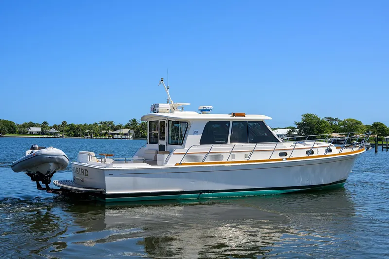 Slide: The Image of 2014 Grand Banks 46 Eastbay SX yacht on calm water, clear sky background. - 13