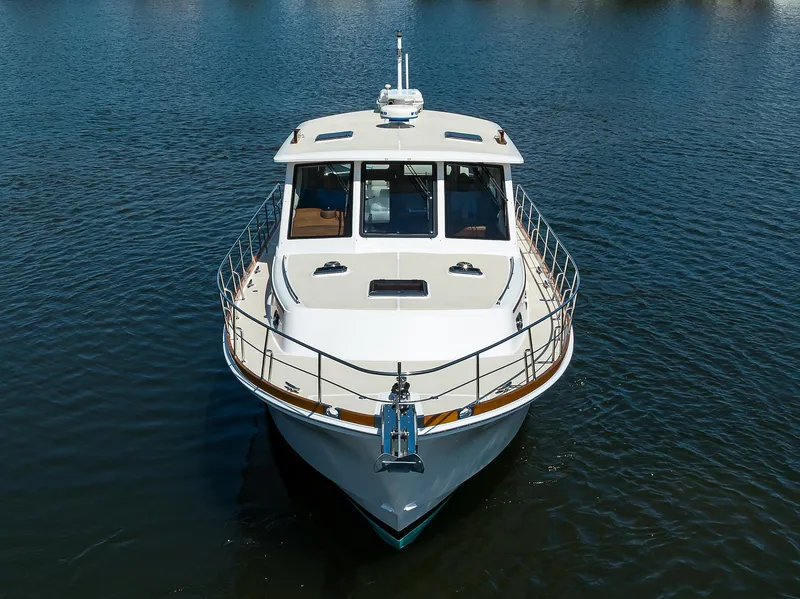 Slide: The Image of 2014 Grand Banks 46 Eastbay SX yacht on calm water, front view. - 15