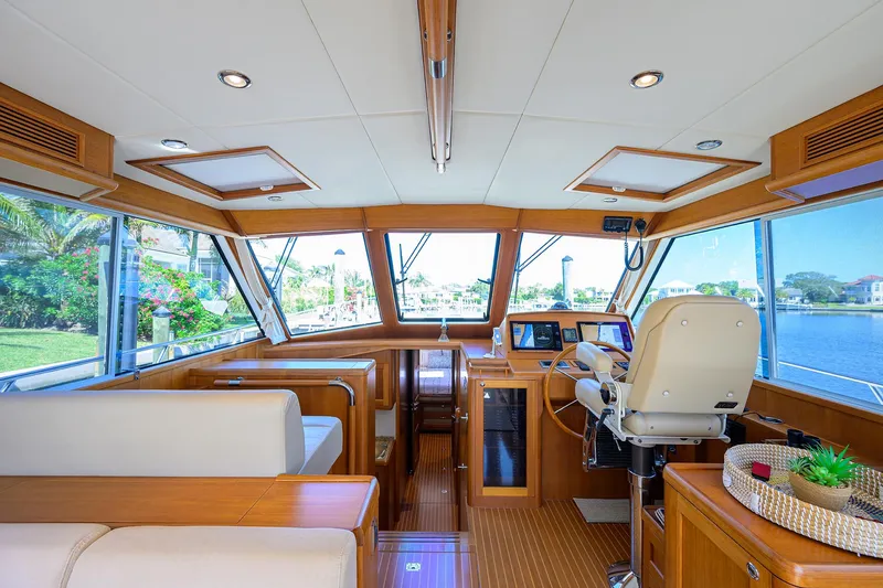 Slide: The Image of Luxurious interior of 2014 Grand Banks 46 Eastbay SX yacht with panoramic windows and elegant seating. - 2