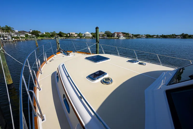 Slide: The Image of 2014 Grand Banks 46 Eastbay SX yacht docked by serene waterfront homes. - 22