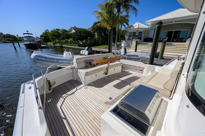 Slide: The Image of 2014 Grand Banks 46 Eastbay SX yacht with spacious deck and seating area by the water. - 27