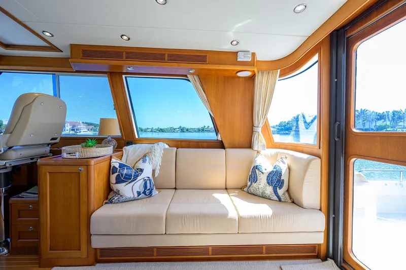 Slide: The Image of Luxurious interior of 2014 Grand Banks 46 Eastbay SX yacht with beige sofa and scenic windows. - 42
