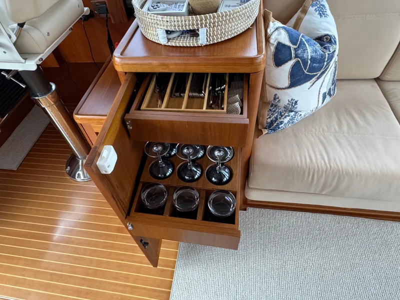 Slide: The Image of Luxurious interior of 2014 Grand Banks 46 Eastbay SX with glassware storage. - 43