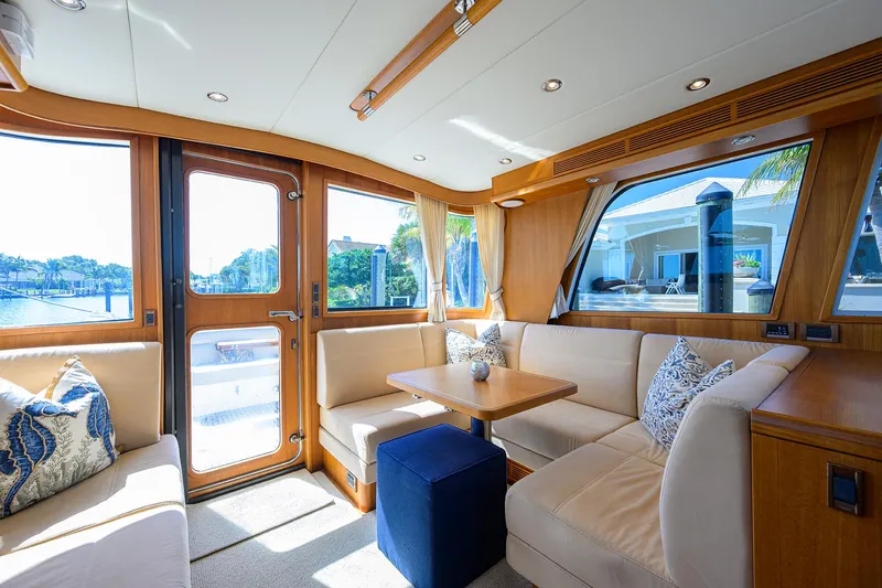 Slide: The Image of Interior of 2014 Grand Banks 46 Eastbay SX yacht with elegant seating and wooden accents. - 44