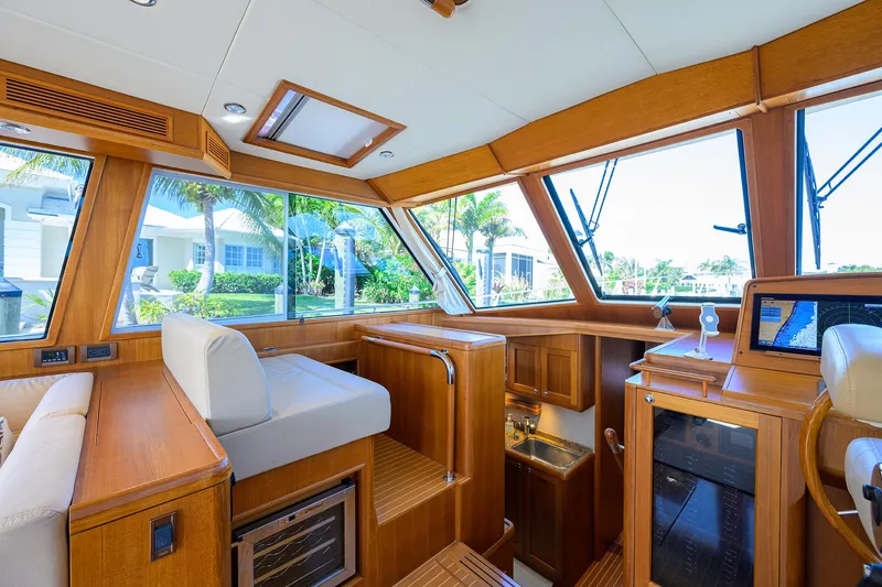 Slide: The Image of Luxurious interior of 2014 Grand Banks 46 Eastbay SX yacht with wooden finishes and large windows. - 48