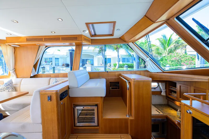 Slide: The Image of Interior of 2014 Grand Banks 46 Eastbay SX yacht, featuring luxurious wood finishes and seating. - 49