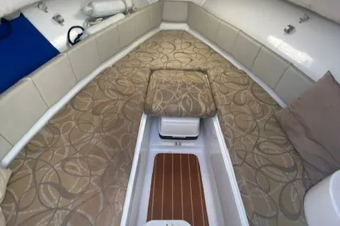 Slide: The Image of 2010 Sea Hunt 225 Victory LE boat interior with patterned cushions and storage. - 11