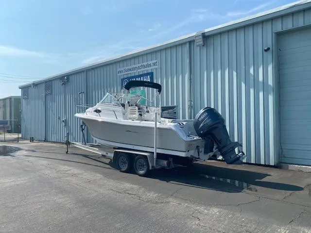 Slide: The Image of 2010 Sea Hunt 225 Victory LE boat on trailer outside a warehouse. - 2