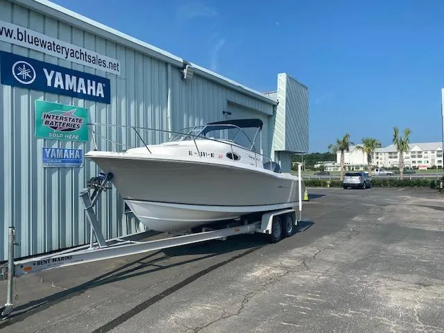 Slide: The Image of 2010 Sea Hunt 225 Victory LE boat on trailer outside Yamaha dealership. - 3