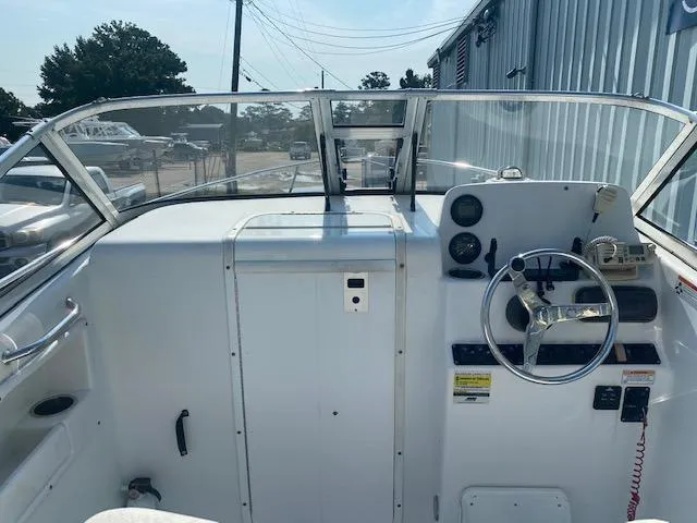 Slide: The Image of 2010 Sea Hunt 225 Victory LE boat cockpit with steering wheel and dashboard controls. - 4