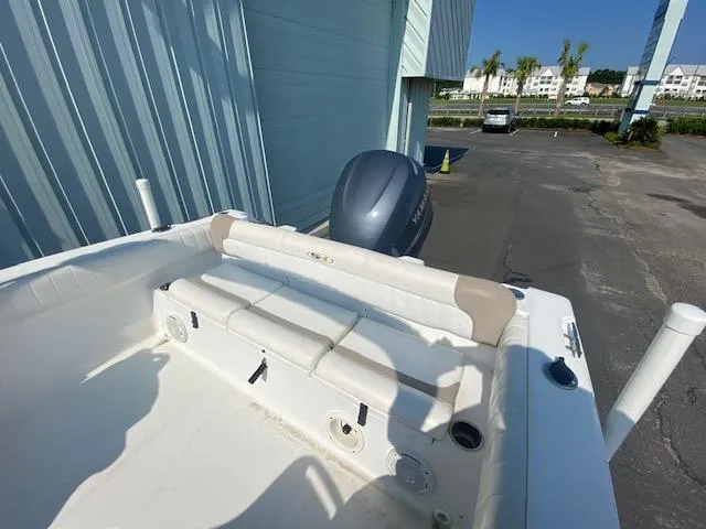 Slide: The Image of 2010 Sea Hunt 225 Victory LE boat with outboard motor, parked near a building. - 6