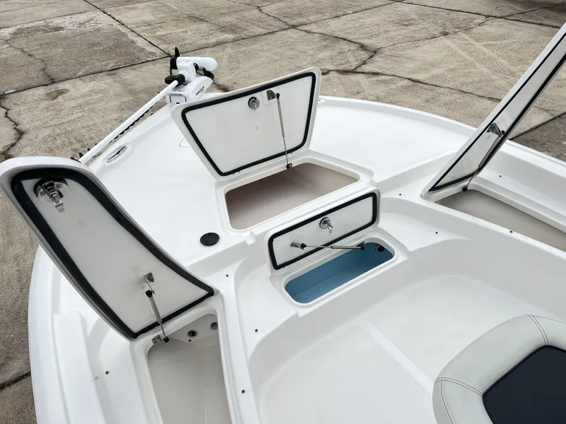 Slide: The Image of 2023 Tidewater 2210 Carolina Bay boat with open storage compartments on deck. - 12