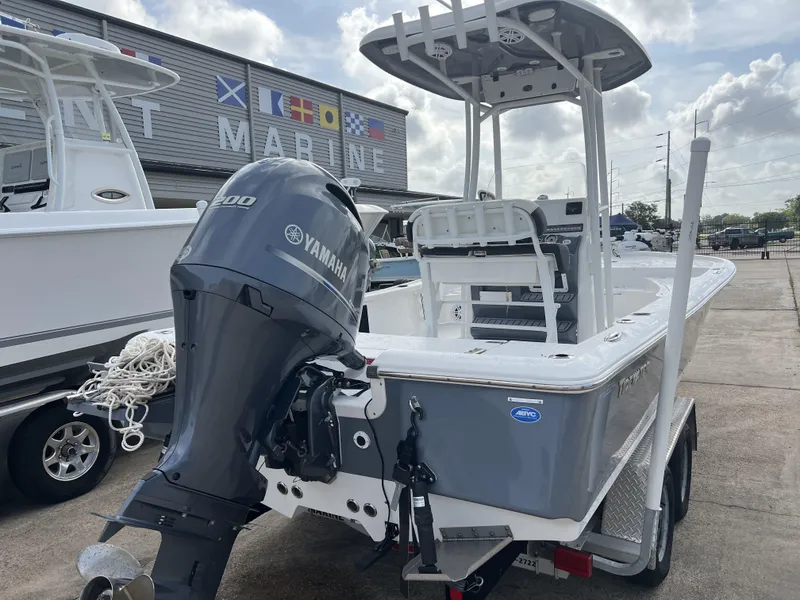 Slide: The Image of 2023 Tidewater 2210 Carolina Bay boat with Yamaha engine at a marina. - 13