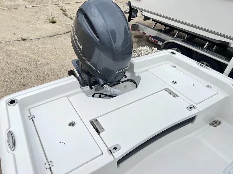 Slide: The Image of 2023 Tidewater 2210 Carolina Bay boat with Yamaha 200 engine, docked on a trailer. - 4