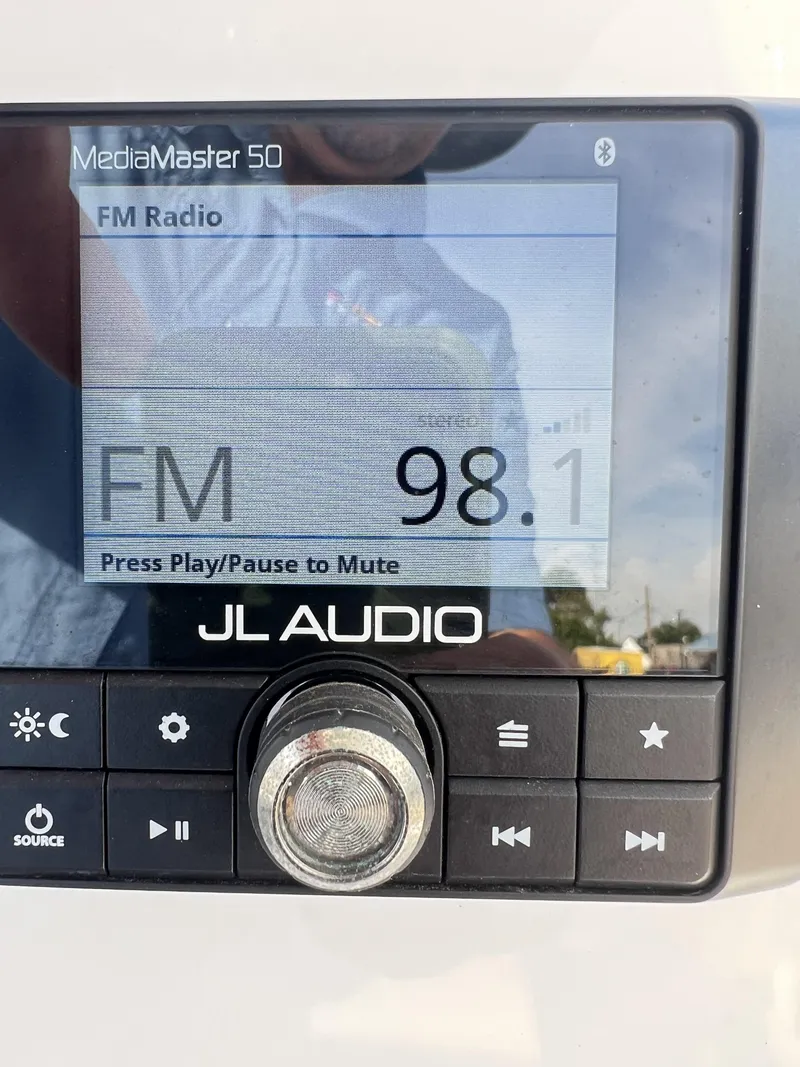 Slide: The Image of JL Audio MediaMaster 50 displaying FM radio tuned to 98.1 on a 2023 Tidewater 2210 Carolina Bay. - 7