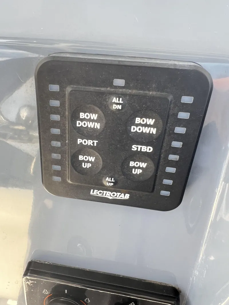 Slide: The Image of Control panel of 2023 Tidewater 2210 Carolina Bay boat with Lectrotab trim tab switches. - 8