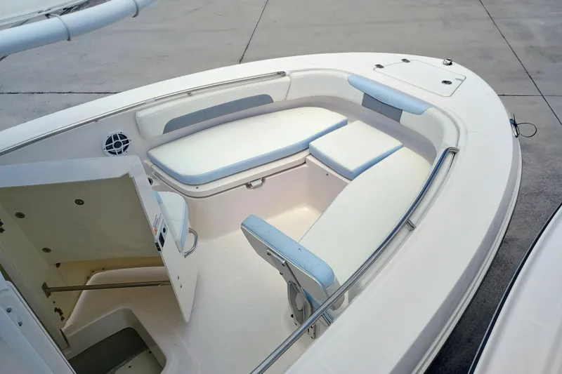Slide: The Image of 2025 Robalo R202 Explorer boat interior with cushioned seating and storage compartments. - 10